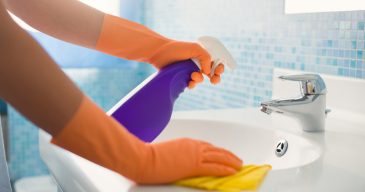 Woman-Doing-Chores-Cleaning-Ba-36893716