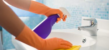 Woman-Doing-Chores-Cleaning-Ba-36893716