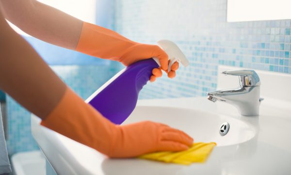 Woman-Doing-Chores-Cleaning-Ba-36893716